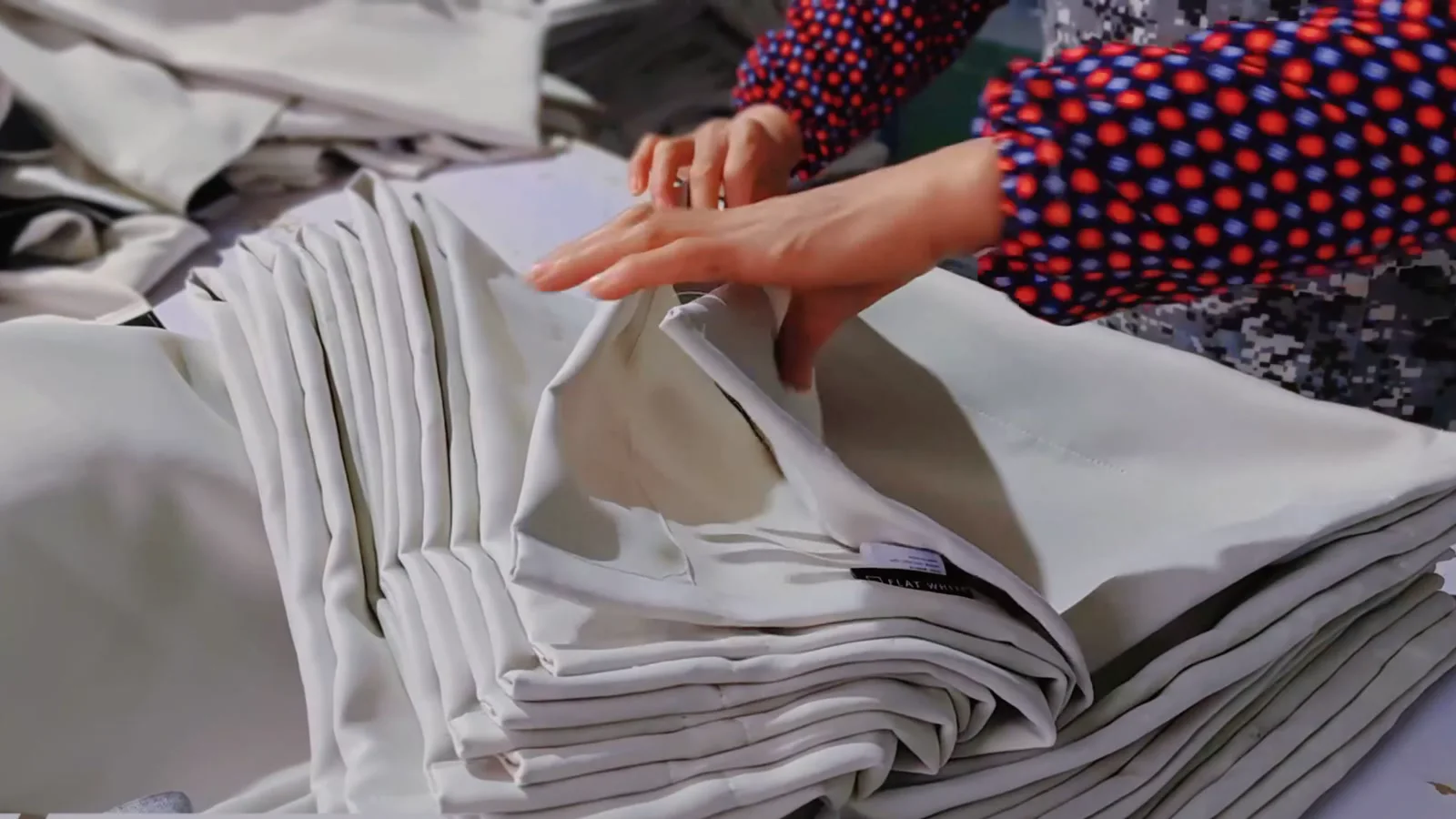 Detailed inspection of finished curtain panels during quality control